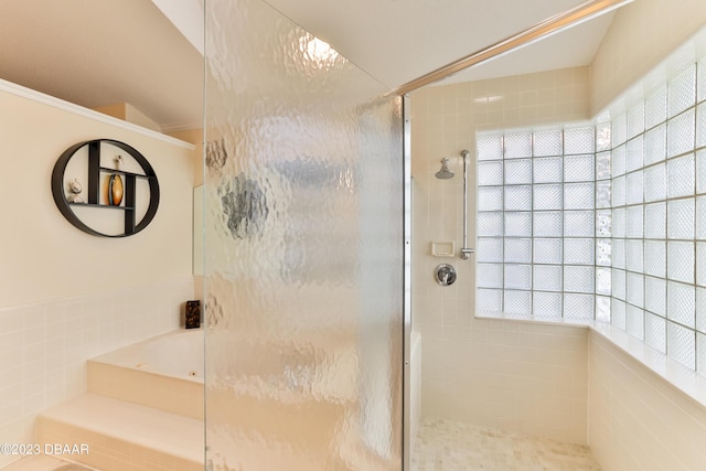 full bathroom featuring a garden tub and a shower stall