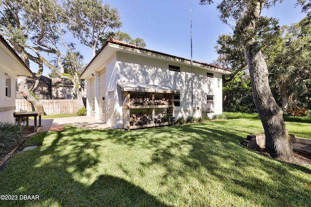 back of house featuring a patio area, fence, cooling unit, and a yard