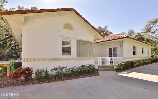 view of front of home featuring a tiled roof and stucco siding