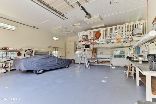 garage featuring a garage door opener and a workshop area