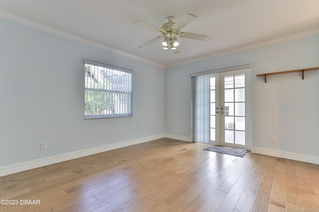 unfurnished room featuring crown molding, french doors, a healthy amount of sunlight, and light wood-style floors