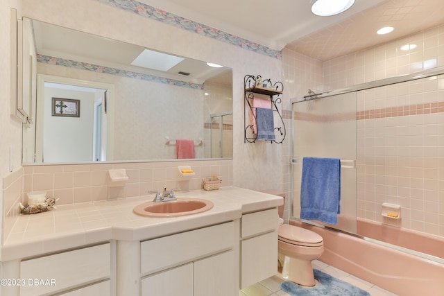 full bathroom with tasteful backsplash, toilet, tile patterned floors, combined bath / shower with glass door, and vanity