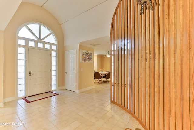 entrance foyer featuring lofted ceiling and baseboards