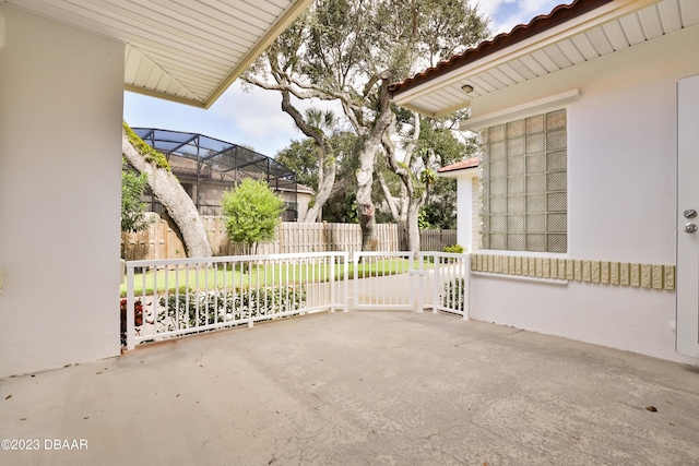 view of patio / terrace with glass enclosure and fence