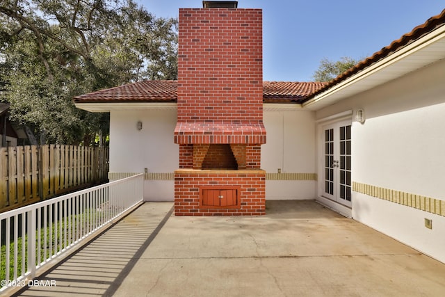 view of patio featuring french doors and fence