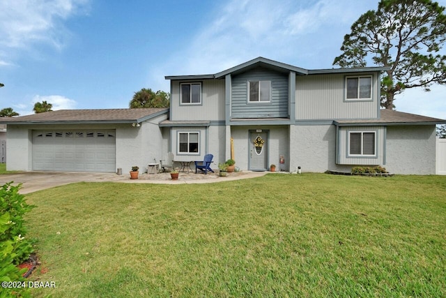 view of property featuring a garage and a front lawn