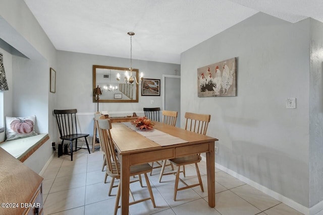 tiled dining area featuring a notable chandelier