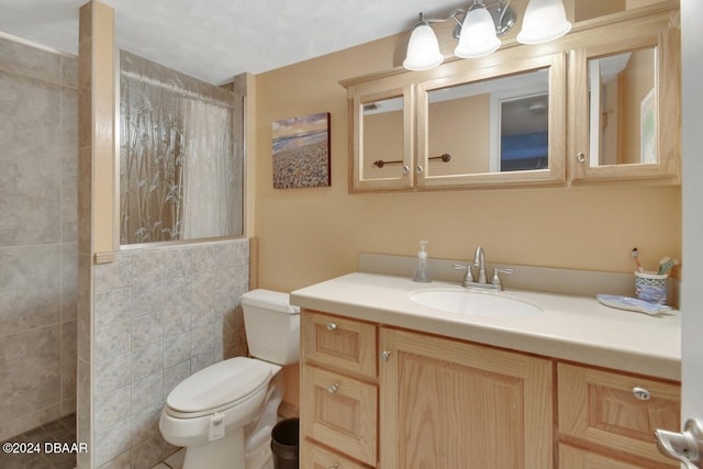 bathroom featuring walk in shower, vanity, tile walls, and toilet