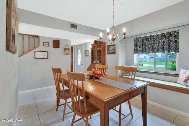 tiled dining area featuring a notable chandelier