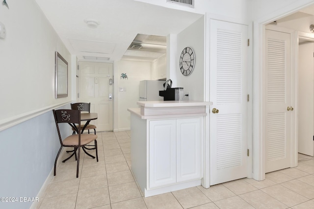 hallway featuring light tile patterned floors