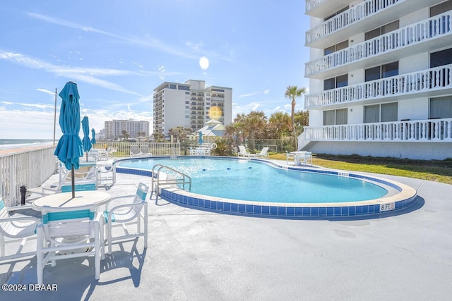 view of swimming pool with a patio area