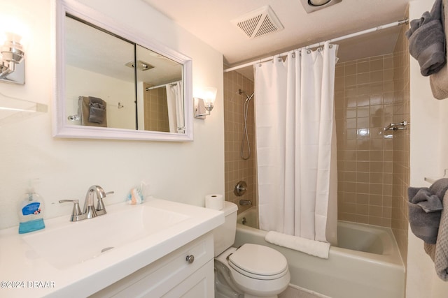 full bathroom with vanity, shower / tub combo with curtain, and toilet