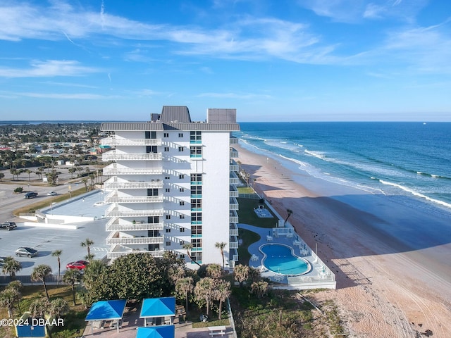 drone / aerial view featuring a water view and a beach view