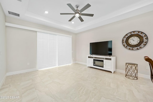 1372 Lombardi Ct, Poinciana, FL 34759 - unfurnished living room featuring a tray ceiling and ceiling fan