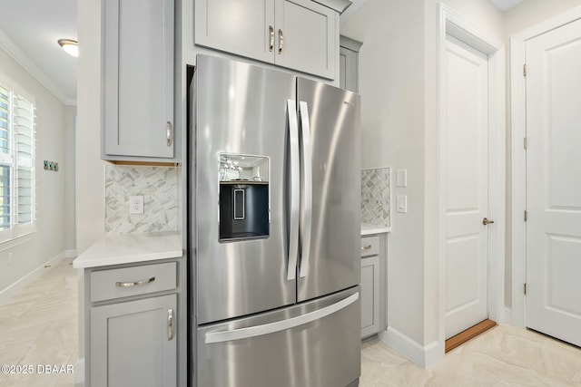 1372 Lombardi Ct, Poinciana, FL 34759 - kitchen with ornamental molding, gray cabinetry, stainless steel fridge, and backsplash