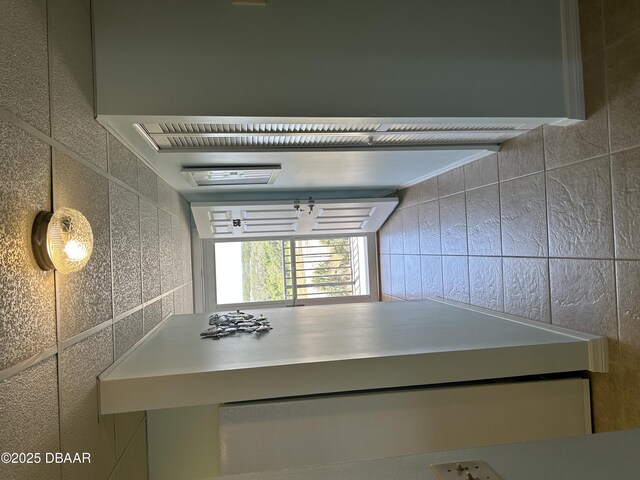 corridor featuring tile walls