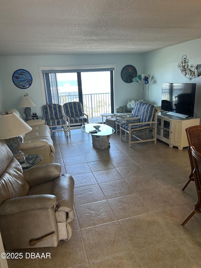living room with tile patterned floors and a textured ceiling