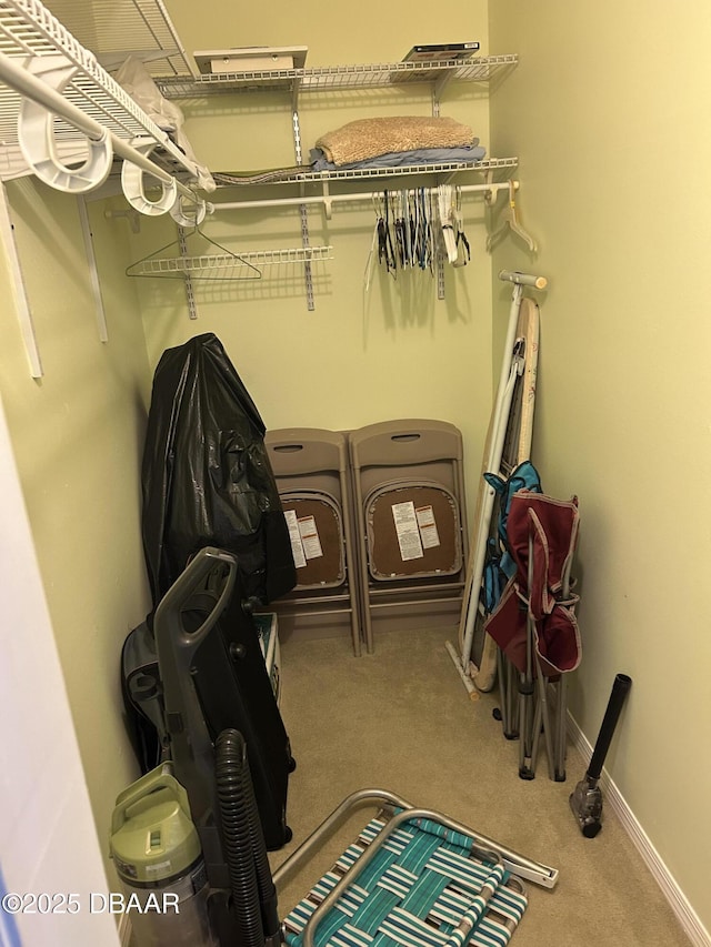 walk in closet with carpet flooring and washer and dryer