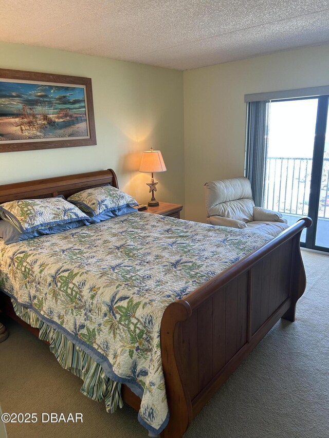bedroom with carpet floors and a textured ceiling