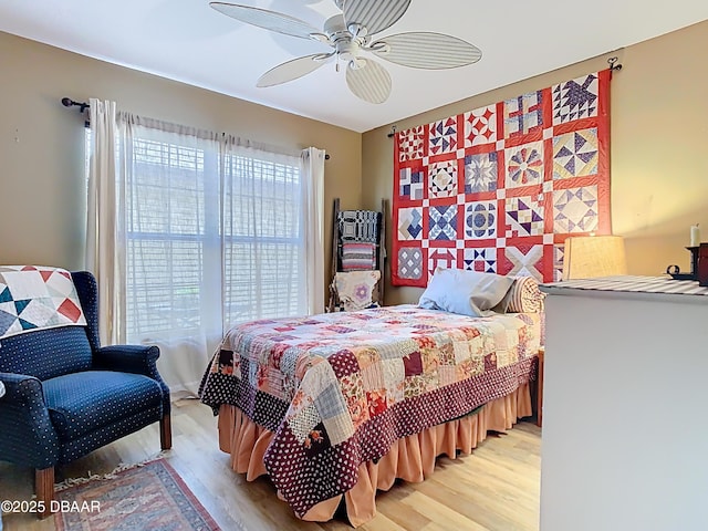 bedroom with light wood-style flooring and a ceiling fan