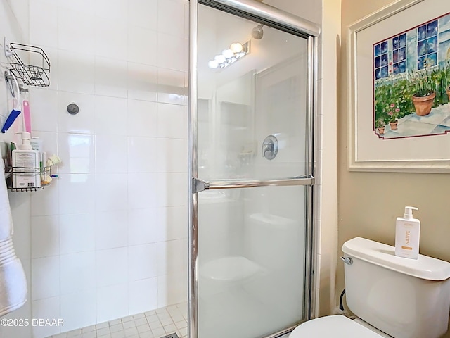 full bath featuring a stall shower and toilet