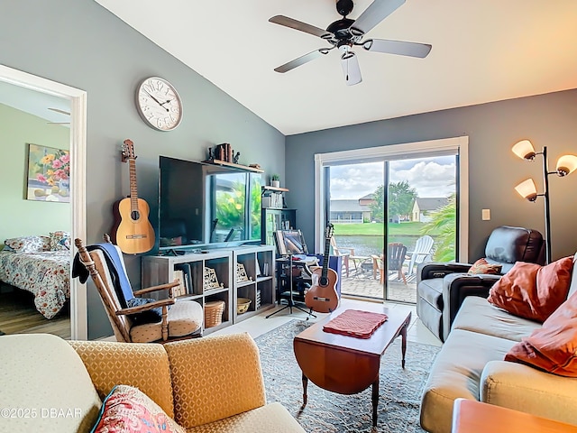 living area featuring lofted ceiling and a ceiling fan
