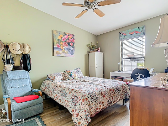 bedroom featuring a ceiling fan and wood finished floors