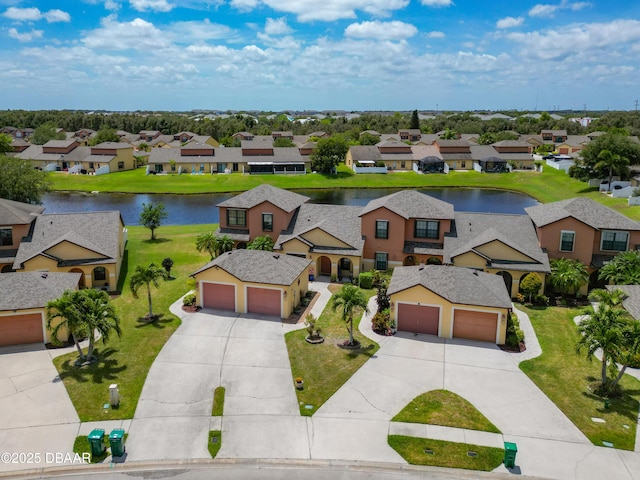 drone / aerial view with a water view and a residential view