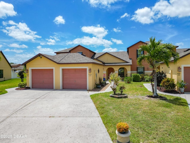 mediterranean / spanish-style house featuring a front yard, stucco siding, driveway, and a garage