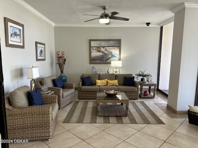 living room featuring ceiling fan, light tile patterned floors, a textured ceiling, and ornamental molding