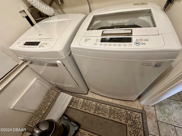 laundry area with tile patterned flooring and washer and dryer