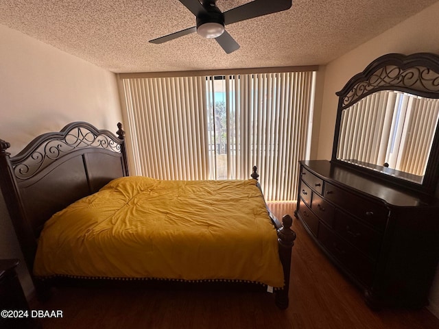 bedroom featuring ceiling fan, dark hardwood / wood-style floors, and a textured ceiling