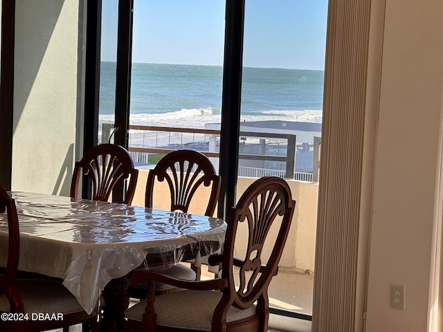 dining space with a water view and a view of the beach