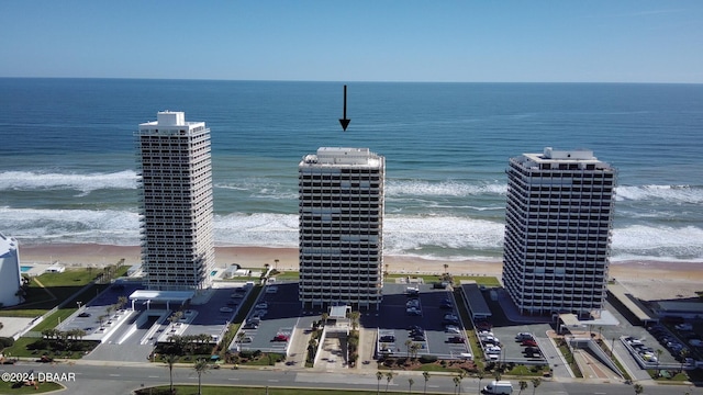 aerial view with a water view and a beach view