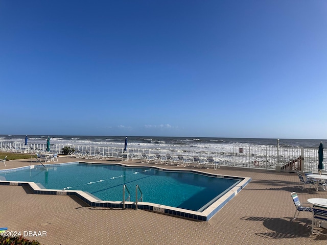 view of pool featuring a water view