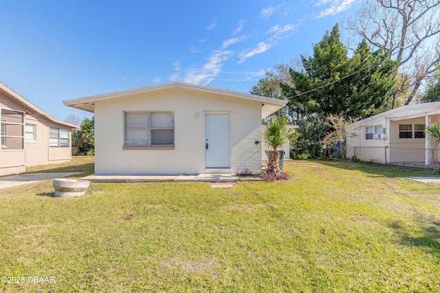 back of property featuring a lawn