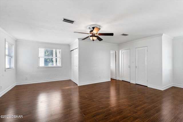 spare room featuring ceiling fan, dark hardwood / wood-style flooring, and crown molding