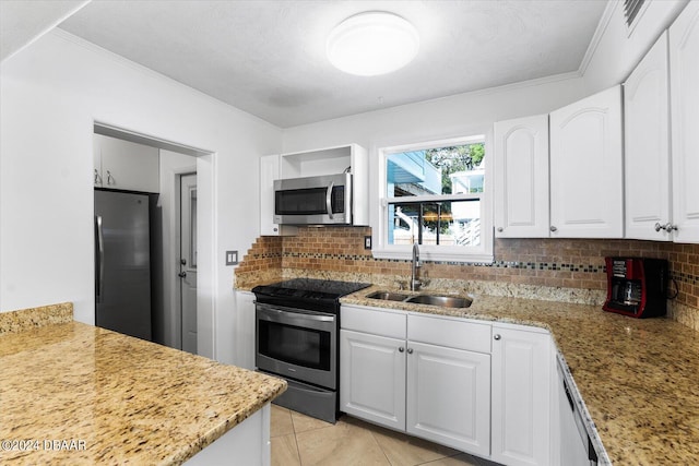 kitchen featuring white cabinets, decorative backsplash, sink, and appliances with stainless steel finishes