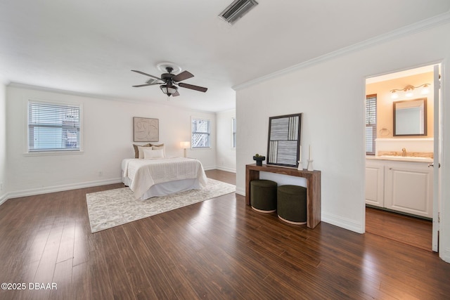 unfurnished bedroom featuring sink, ornamental molding, ceiling fan, dark wood-type flooring, and ensuite bath