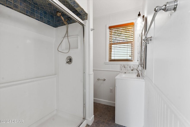 bathroom featuring vanity and a shower with shower door