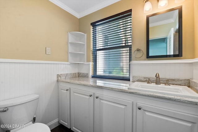 bathroom with vanity, ornamental molding, and toilet