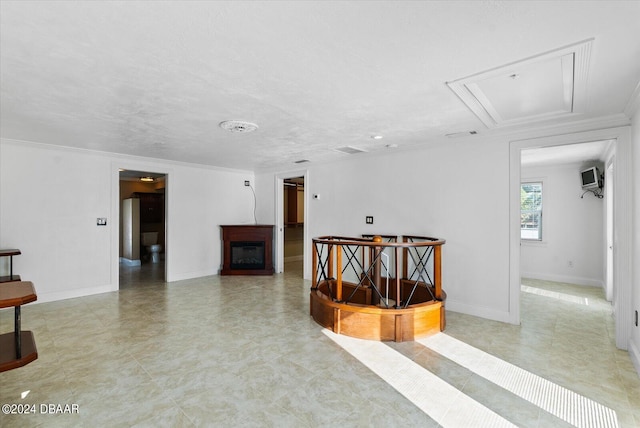 interior space with a textured ceiling and crown molding