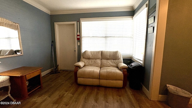 living area with ornamental molding, a wealth of natural light, and dark hardwood / wood-style floors