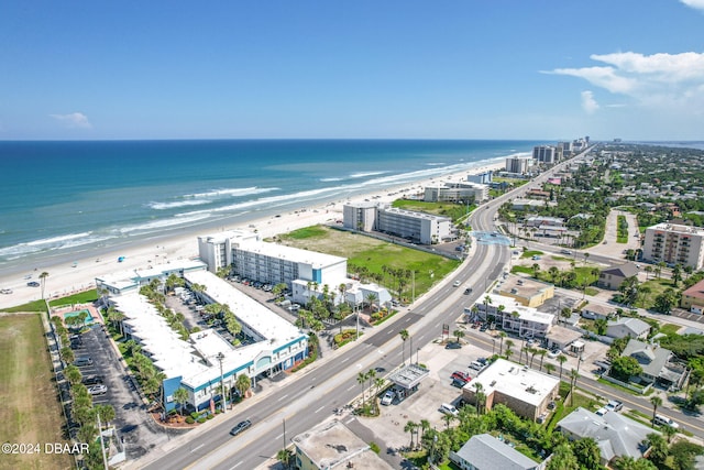 drone / aerial view featuring a view of the beach and a water view