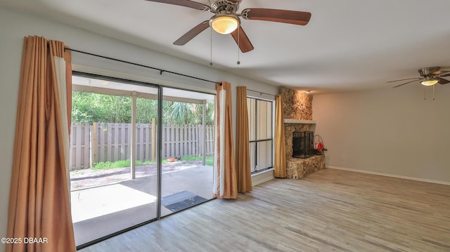 8 Fox Run Trl, Ormond Beach, FL 32174 - unfurnished living room with ceiling fan, wood finished floors, and a fireplace
