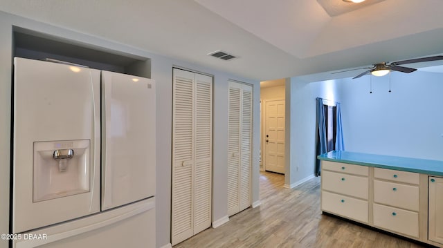 8 Fox Run Trl, Ormond Beach, FL 32174 - kitchen with white refrigerator with ice dispenser, ceiling fan, and light wood-style floors