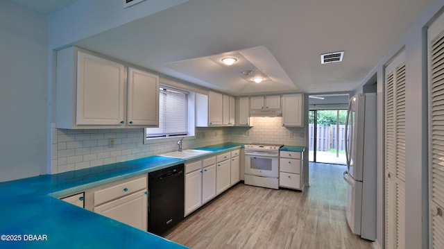 8 Fox Run Trl, Ormond Beach, FL 32174 - kitchen with white appliances, healthy amount of natural light, backsplash, and white cabinetry