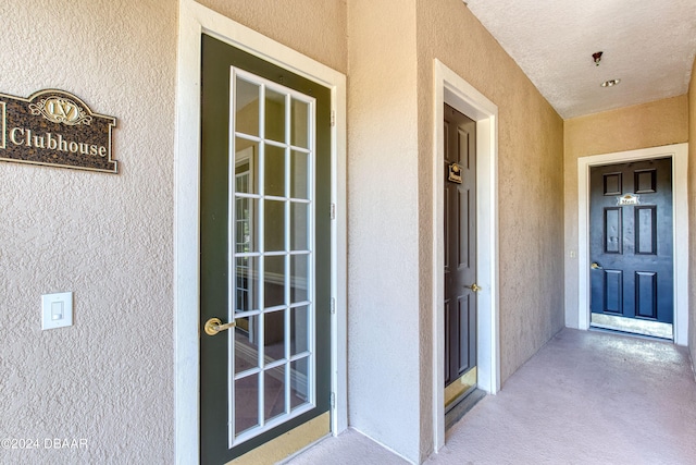 940 Village Trl Unit 2-207, Port Orange, FL 32127 - doorway to property with stucco siding