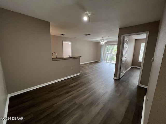 940 Village Trl Unit 2-207, Port Orange, FL 32127 - unfurnished room with dark wood finished floors, a ceiling fan, baseboards, and a sink