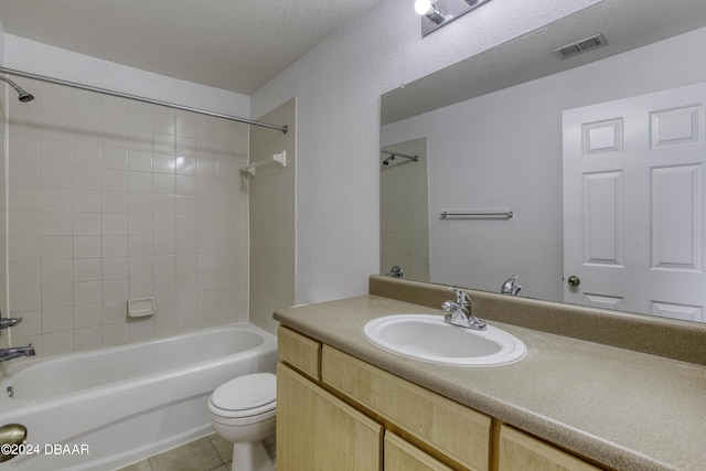 940 Village Trl Unit 2-207, Port Orange, FL 32127 - bathroom with toilet, shower / tub combination, tile patterned floors, vanity, and a textured ceiling